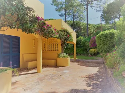 a yellow house with flowers growing on it at Fashion Villa in Vilamoura with Private Pool in Quarteira