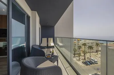 a balcony with chairs and a view of the beach at Terracos de Quarteira II Eden by Real Properties in Quarteira