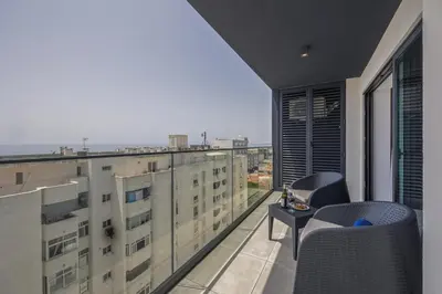 an apartment balcony with a view of the city at Terracos de Quarteira II Eden by Real Properties in Quarteira
