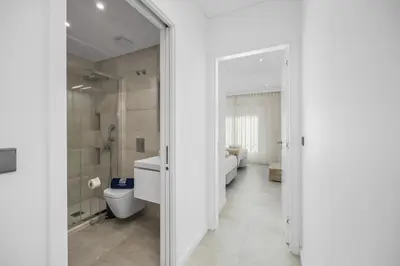 a white bathroom with a toilet and a shower at Terraços de Quarteira II Frolic by Real Properties in Cavacos