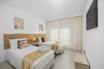 a hotel room with two beds and a window at Terraços de Quarteira II Frolic by Real Properties in Cavacos
