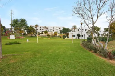 a park in front of a white building at Ema Clube em Albufeira in Albufeira