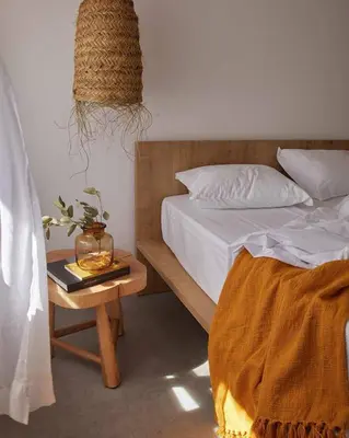a bedroom with a bed and a table with a night stand at Casa Pateo in Albufeira