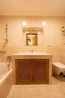 a bathroom with a sink and a toilet and a mirror at Miradouro da Penha in Faro