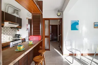 a kitchen with a counter and chairs in it at Good Wave House in Vilamoura