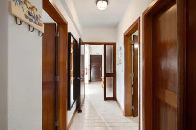 a hallway with many doors and a tile floor at Good Wave House in Vilamoura