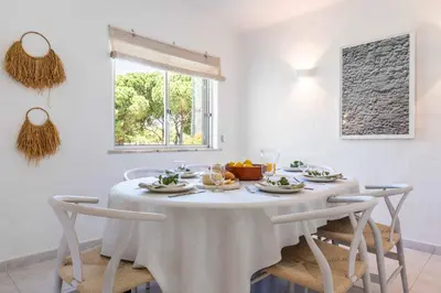 a living room with a white couch and a table at Sunny Vilamoura Golf Villa with Private Pool in Quarteira