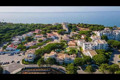 an aerial view of a residential neighborhood next to the ocean at Falésia Modern Flat W/Balcony & Pool by LovelyStay in Albufeira