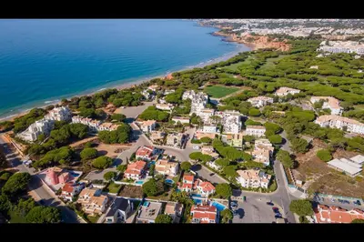 an aerial view of a town next to the ocean at Falésia Modern Flat W/Balcony & Pool by LovelyStay in Albufeira