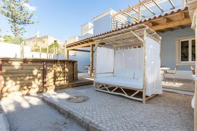 a pergola with a swing on a patio at Amália Boutique Suites & Studios - by @ rita´s place in Faro