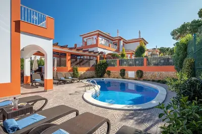 a house with a swimming pool in a yard at 7+1 BEDROOM PRIVATE VILLA, HEATED POOL, GAMES, BBQ in Albufeira