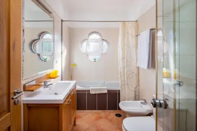 a bathroom with a sink and a toilet and a shower at 7+1 BEDROOM PRIVATE VILLA, HEATED POOL, GAMES, BBQ in Albufeira