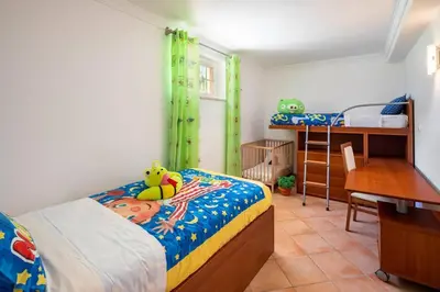 a bedroom with two bunk beds and a desk at 7+1 BEDROOM PRIVATE VILLA, HEATED POOL, GAMES, BBQ in Albufeira