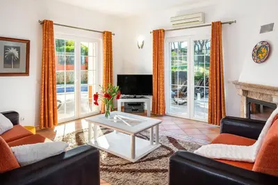 a living room with a couch and a table at 7+1 BEDROOM PRIVATE VILLA, HEATED POOL, GAMES, BBQ in Albufeira