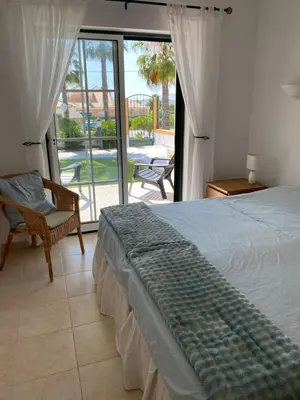 a bedroom with a bed and a view of a patio at Casa Rachael in Albufeira