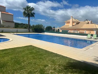 a swimming pool in the backyard of a house at Casa Rachael in Albufeira