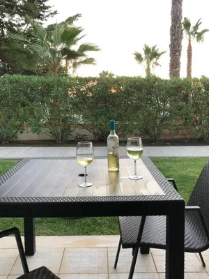 a table with two glasses and a bottle of wine at Casa Rachael in Albufeira