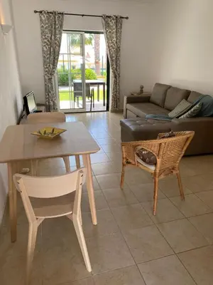a living room with a table and a couch at Casa Rachael in Albufeira