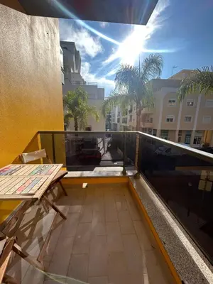 a bedroom with a bed and a large window at Casa Paula in Quarteira