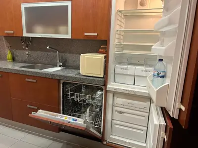 a kitchen with a red and white checkered table at Casa Paula in Quarteira