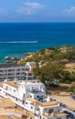 a large white building with the ocean in the background at HIMALAYA ROOFTOP Sea VIEW in Albufeira