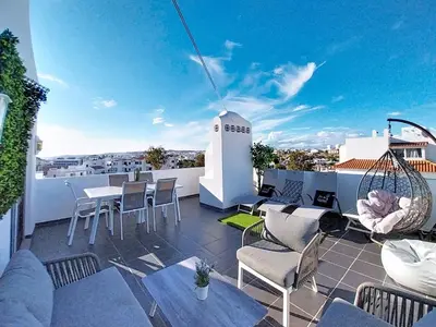 a patio with chairs and tables on a roof at HIMALAYA ROOFTOP Sea VIEW in Albufeira