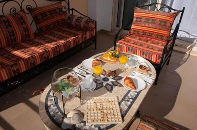 a living room with a table with breakfast foods on it at Encosta da Orada by OCvillas in Albufeira