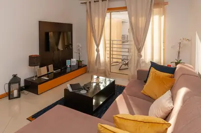 a living room with a couch and a tv at Encosta da Orada by OCvillas in Albufeira