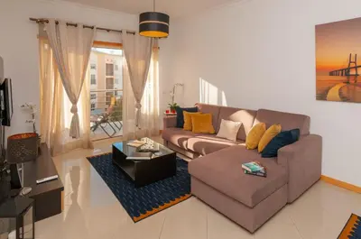 a living room with a couch and a coffee table at Encosta da Orada by OCvillas in Albufeira