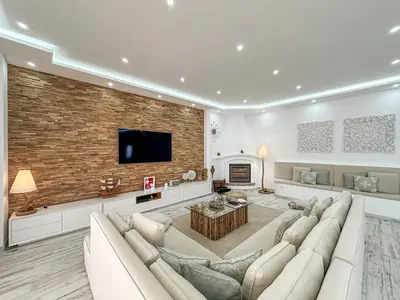 a living room with a couch and a fireplace at Luxury Villa Heated Pool, walk to São Rafael Beach, Albufeira in Albufeira
