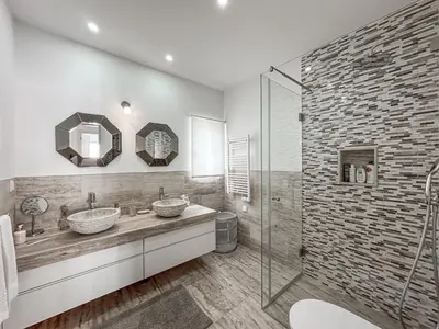a bathroom with two sinks and a glass shower at Luxury Villa Heated Pool, walk to São Rafael Beach, Albufeira in Albufeira
