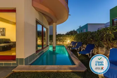 a swimming pool in the backyard of a house at Marina de Albufeira Villa 8 in Albufeira