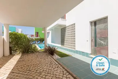 a house with a pool and a sign that says clean and safe at Marina de Albufeira Villa 8 in Albufeira