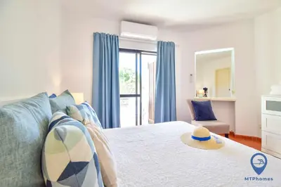 a bedroom with a bed with a hat on it at Balaia Golf by MTPhomes in Albufeira
