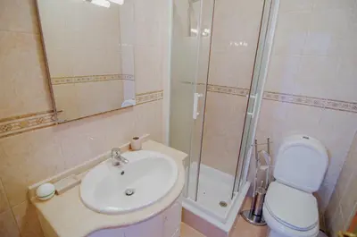 a bathroom with a sink and a shower and a toilet at Dalia in Quarteira