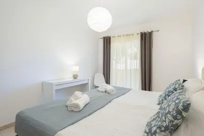 a bedroom with a bed with towels on it at Centralgarve - Spacious & Elegant - Vilamoura w Pool - Jacarandás in Quarteira