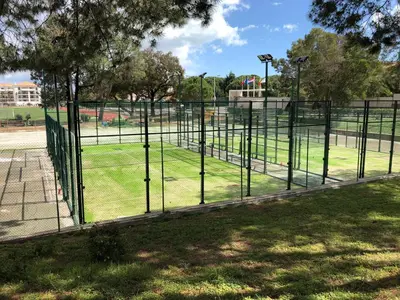 a fence in a park with a field of grass at Falésia Cliff Apartment by The Portuguese Butler in Albufeira