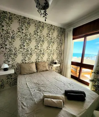 a bedroom with a large bed with a view of the ocean at OceanView Side in Quarteira