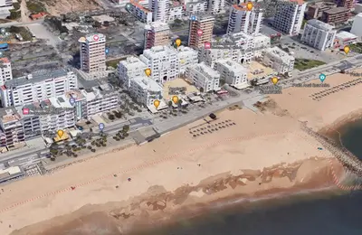 an aerial view of a beach with buildings and a city at OceanView Side in Quarteira