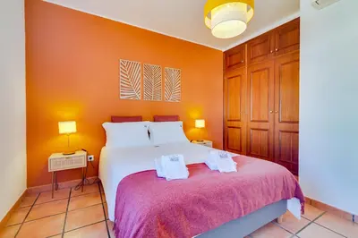 a bedroom with a white bed and two lamps at Villa Oliveiras de Vilamoura by The Portuguese Butler in Quarteira