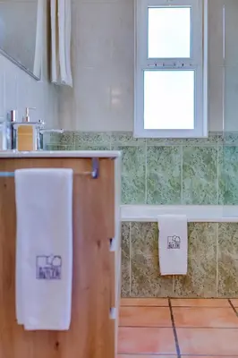 a kitchen with two white towels on a counter at Villa Oliveiras de Vilamoura by The Portuguese Butler in Quarteira