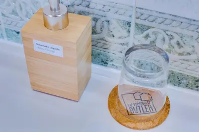 a bottle of water next to a wooden box at Villa Oliveiras de Vilamoura by The Portuguese Butler in Quarteira