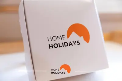 a box with a home holidays sign on it at #130 Praia Village by Home Holidays in Vilamoura