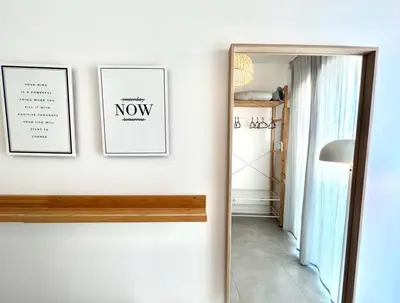 a hallway with two pictures and a mirror on a wall at Casa Diogo in Faro