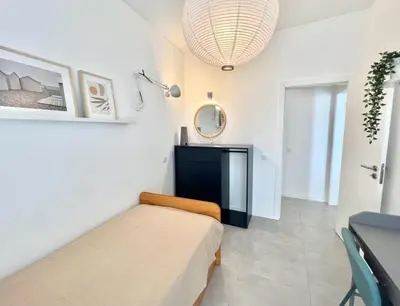 a bedroom with a bed and a mirror on the wall at Casa Diogo in Faro