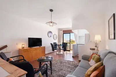 a living room with a couch and a tv at Apartment Montechoro in Albufeira