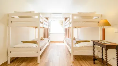 a bedroom with two beds with red pillows at Villa Royal Sandals by Algarve Vacation in Albufeira