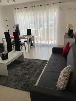 a living room with a couch and a table at Apartamentos Mar-Sol Villas in Vilamoura