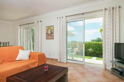 a living room with an orange bed and a sliding glass door at ABF36V2 Charming 2 bdr villa located only a few mi in Albufeira