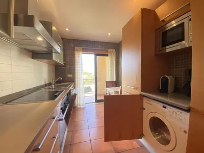 a kitchen with a sink and a washing machine at Albufeira Sunny Style With Pool by Homing in Albufeira